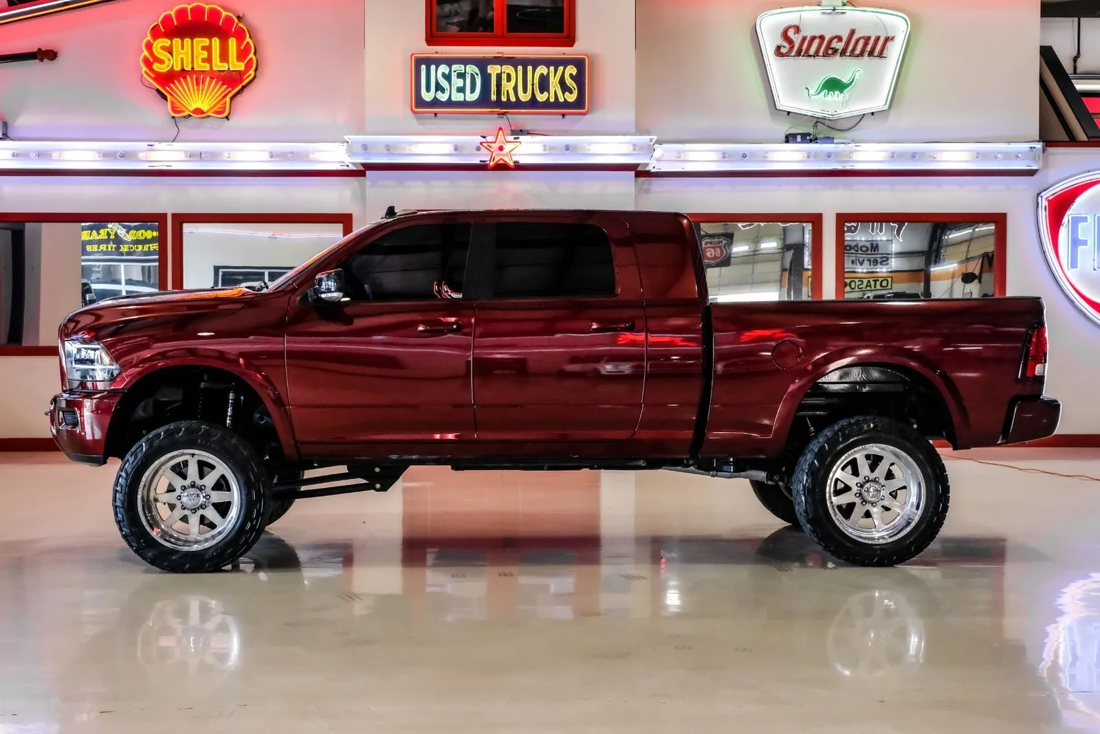 Lifted Ram 2500 4x4 crew cab in maroon, bought by Texas Motorcars